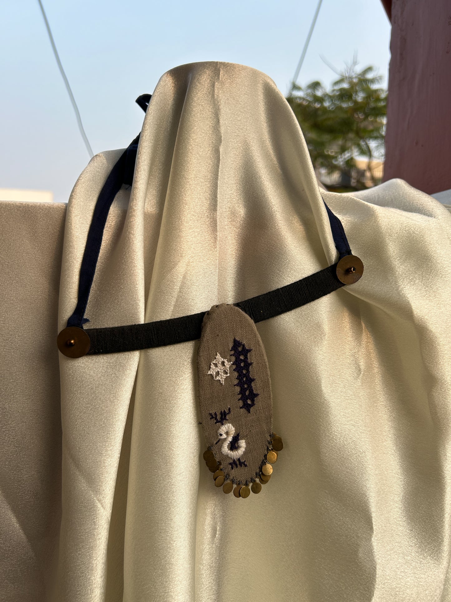 Oval embroidered grey necklace